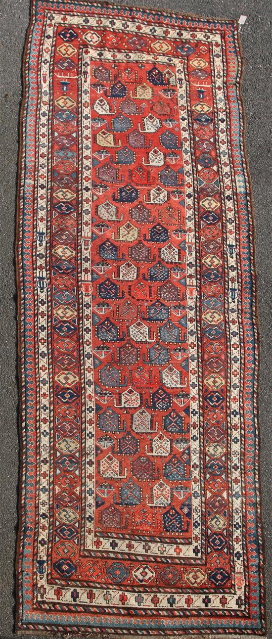 A Gendje red ground runner, c.1900, 13ft 4in by 4ft.